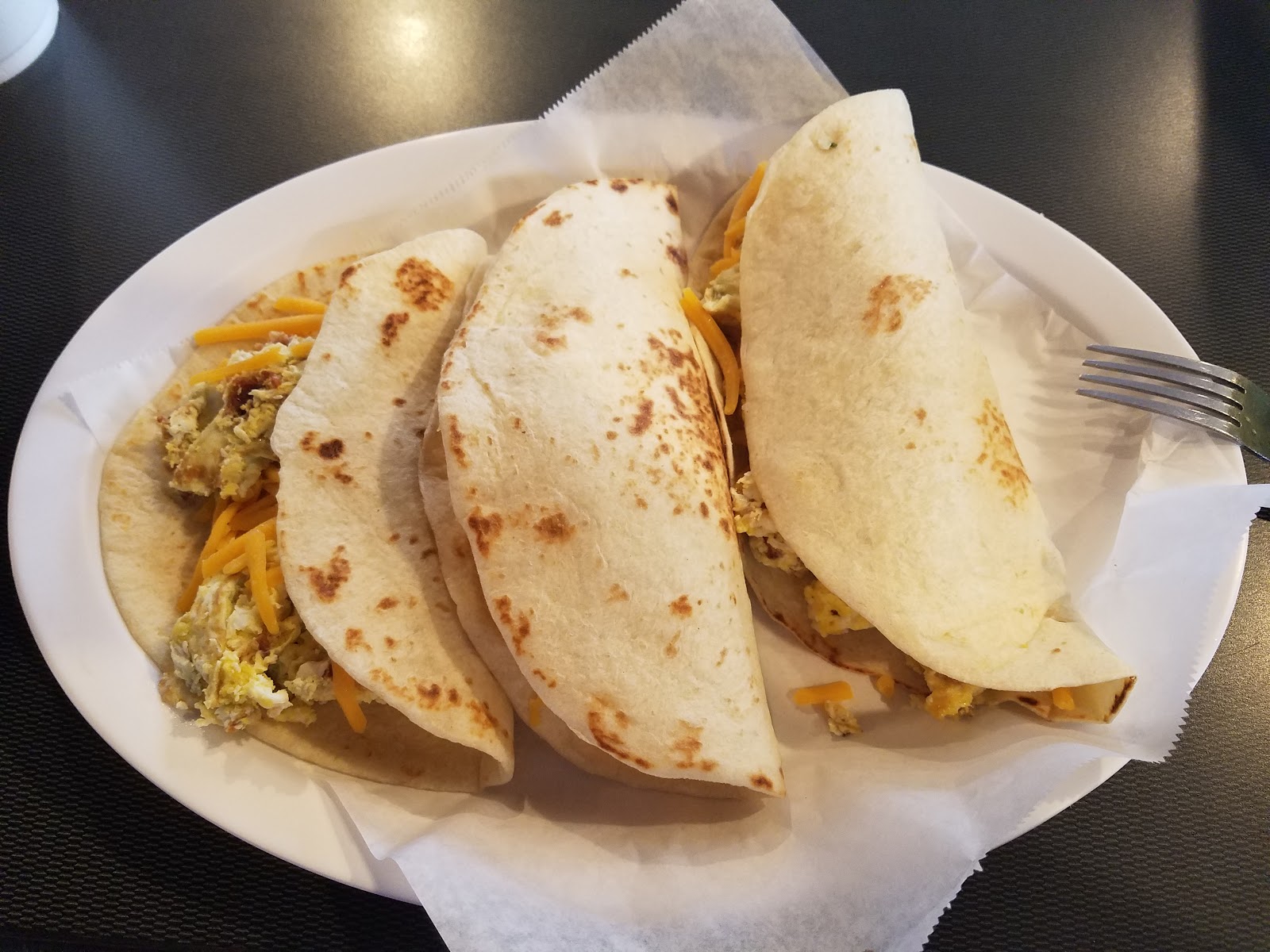 Breakfast tacos with egg and cheese on flour tortillas